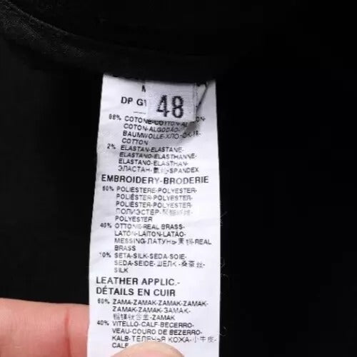Tag on a garment indicating details such as fabric type, care instructions, and other product information
