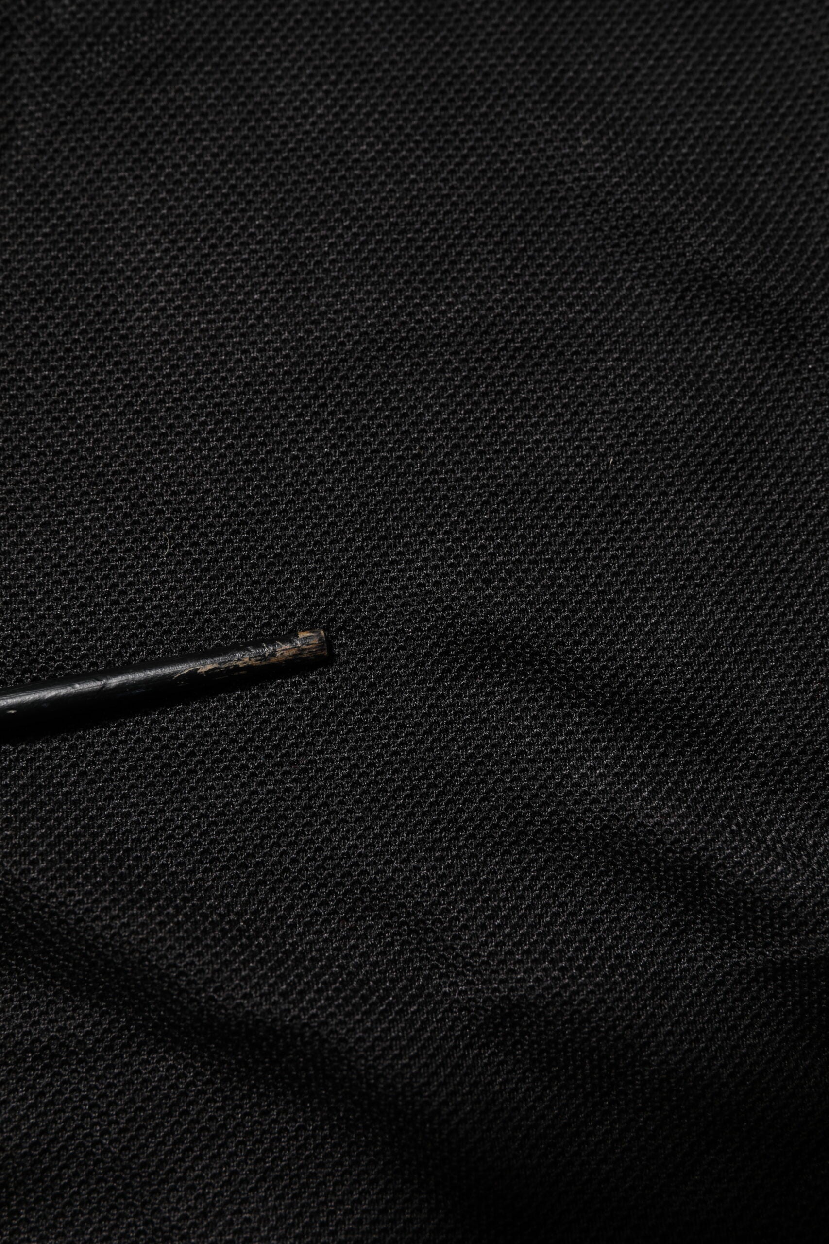 Black fabric with a small black object on top