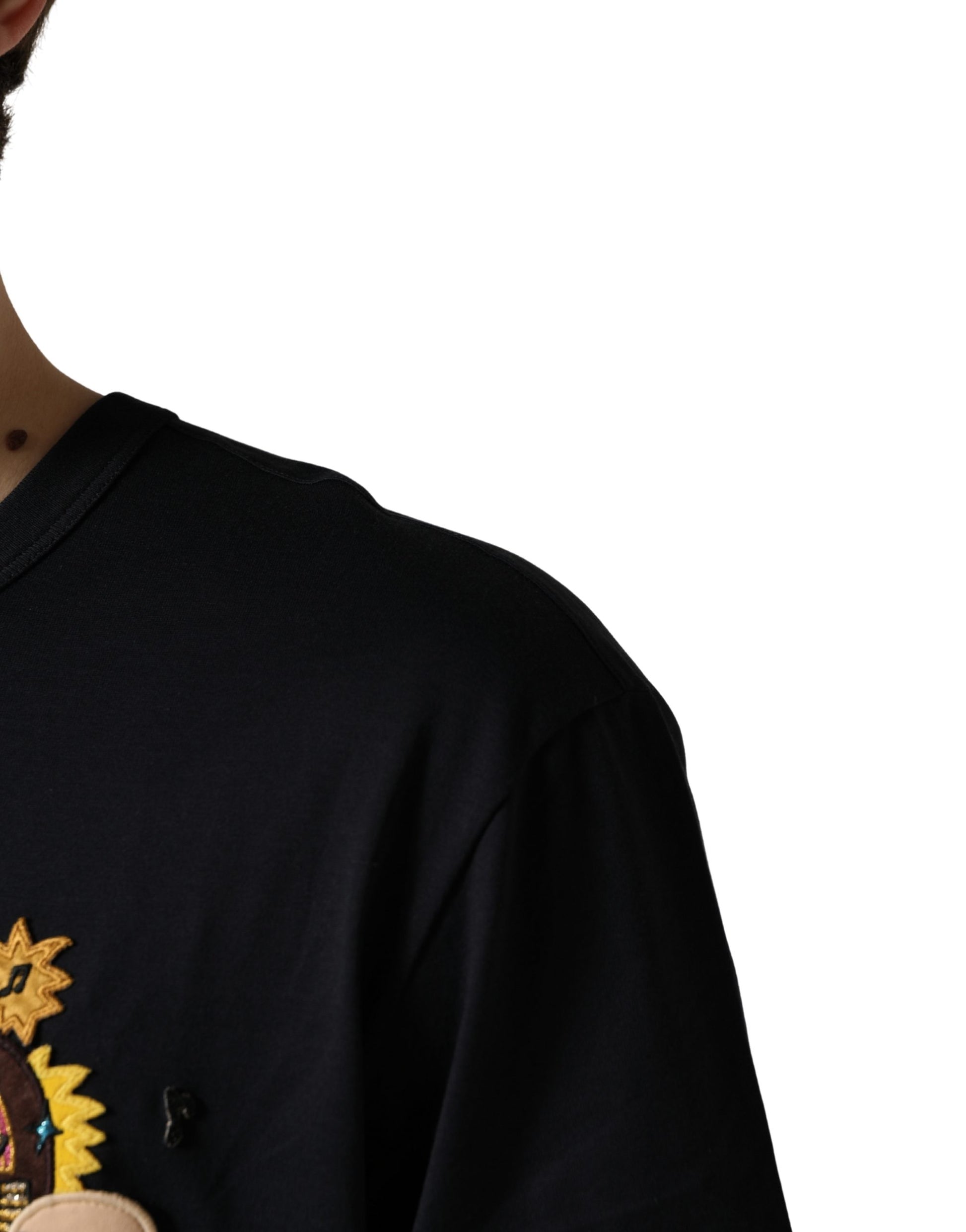 A person wearing a dark blue sweatshirt with a graphic design on the front