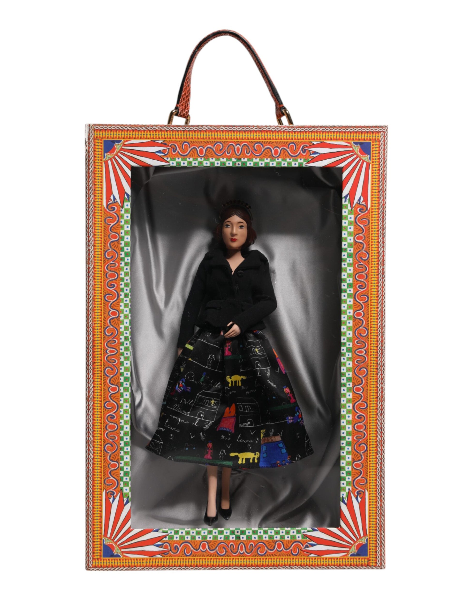 A ceramic porcelain doll wearing a black dress with colorful designs