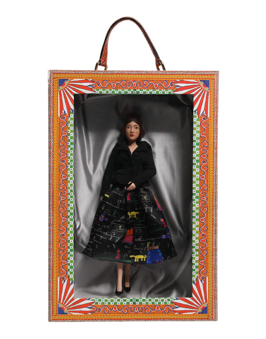 A ceramic porcelain doll wearing a black dress with colorful designs