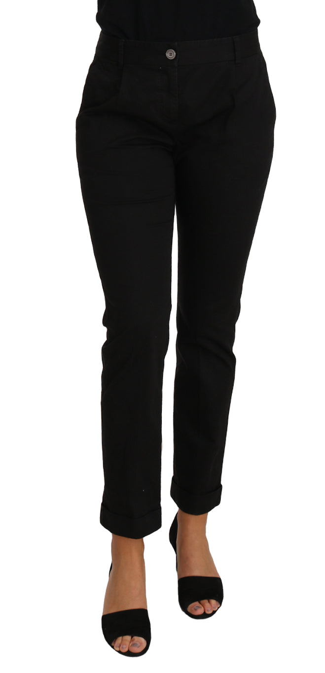 Woman wearing black pants and black heels