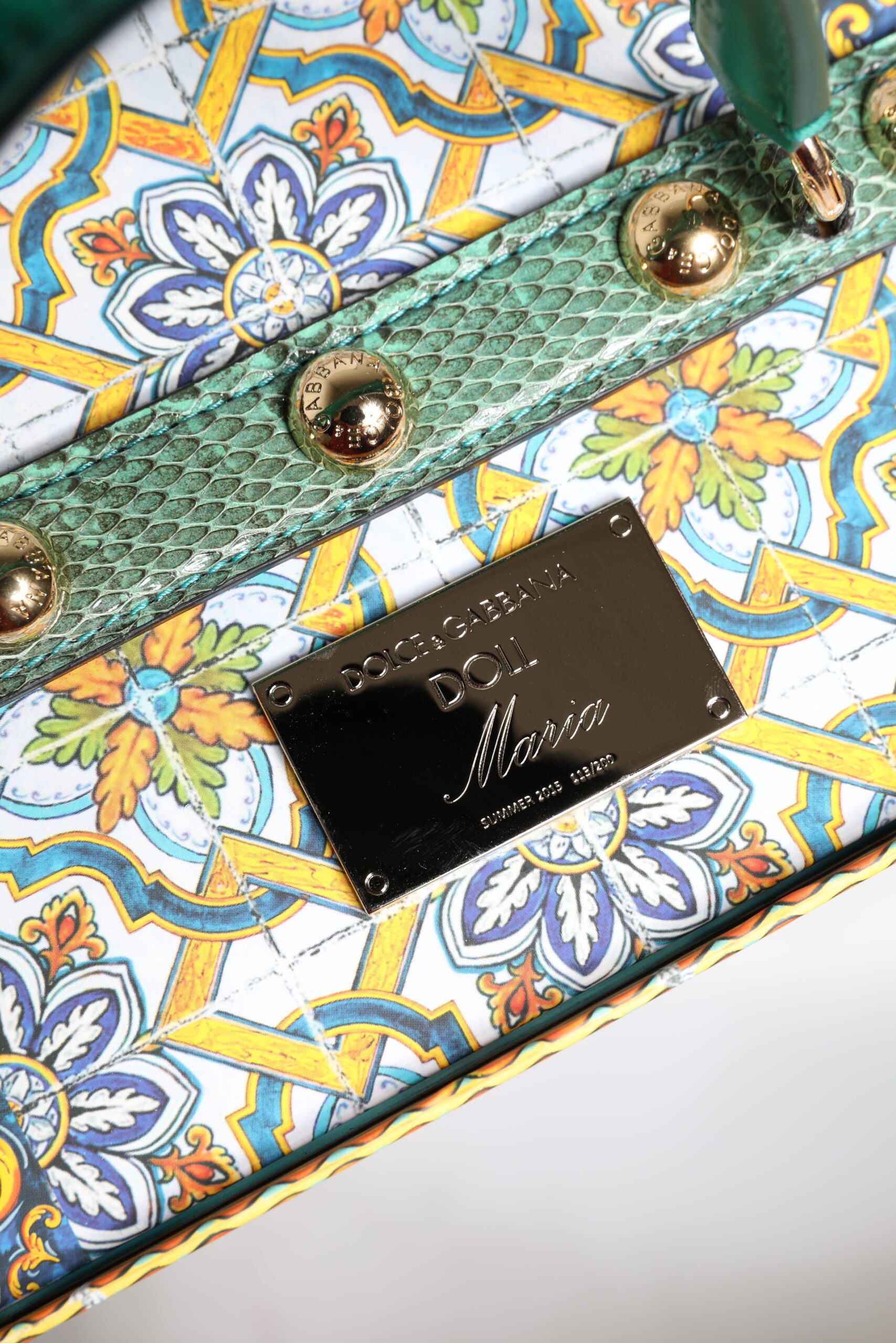 A handbag with a floral pattern and leather straps
