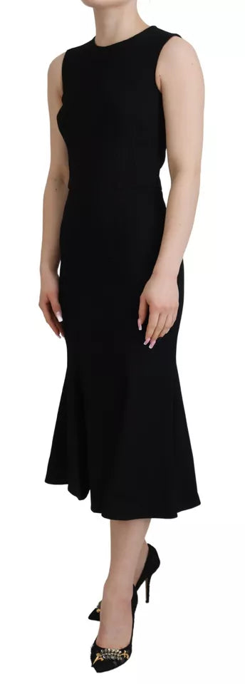 A black dress with a sheath silhouette, flare skirt and viscose fabric