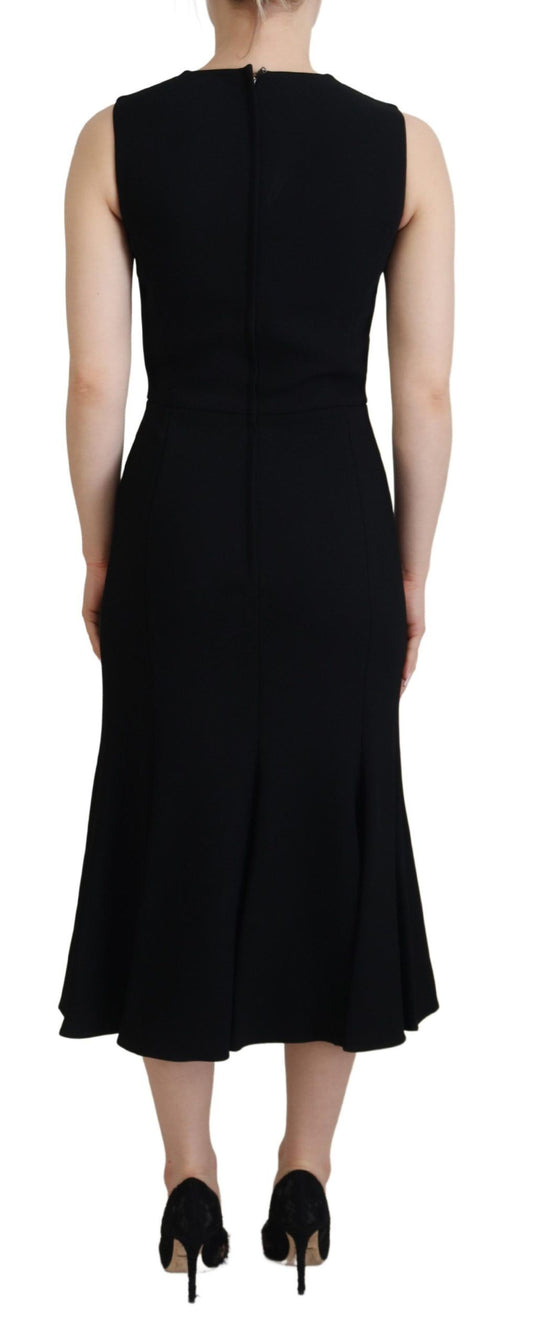 A black dress with a sheath silhouette and flared skirt, made of viscose fabric
