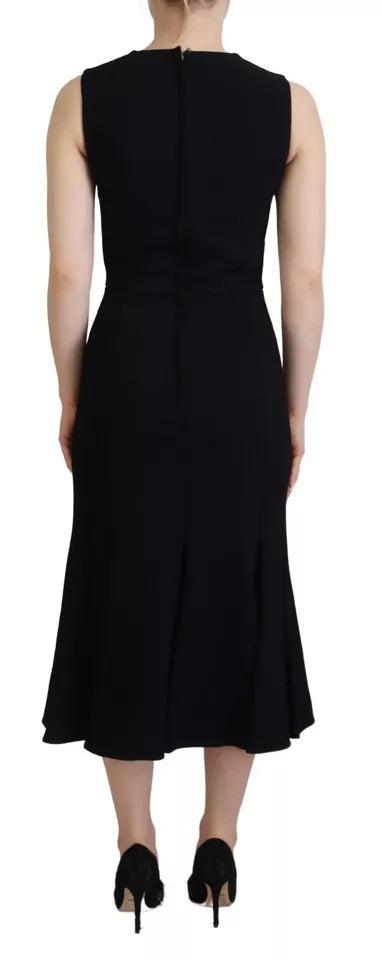 A black dress with a sheath silhouette, flare skirt and viscose material