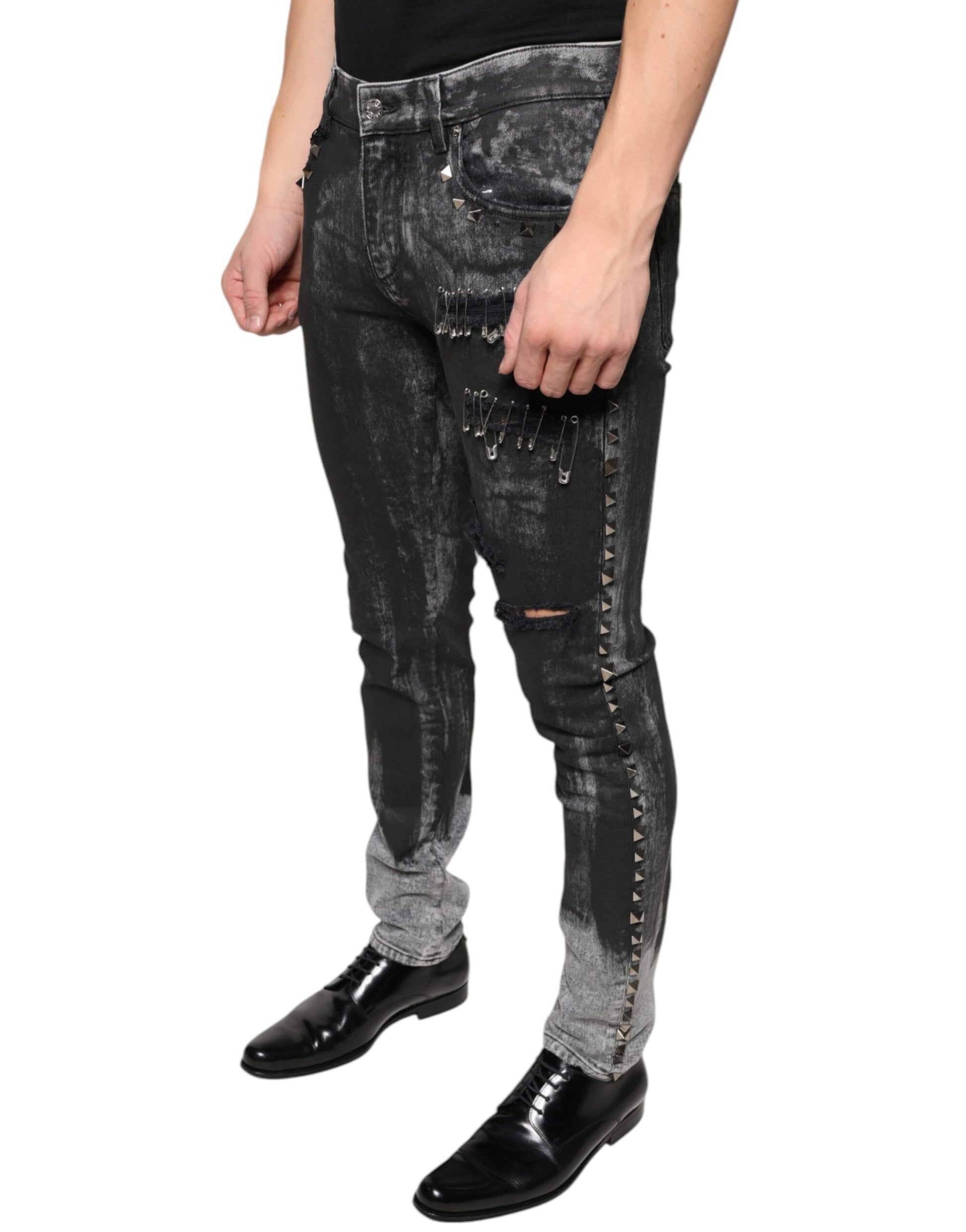 Man wearing distressed jeans with studs and rips