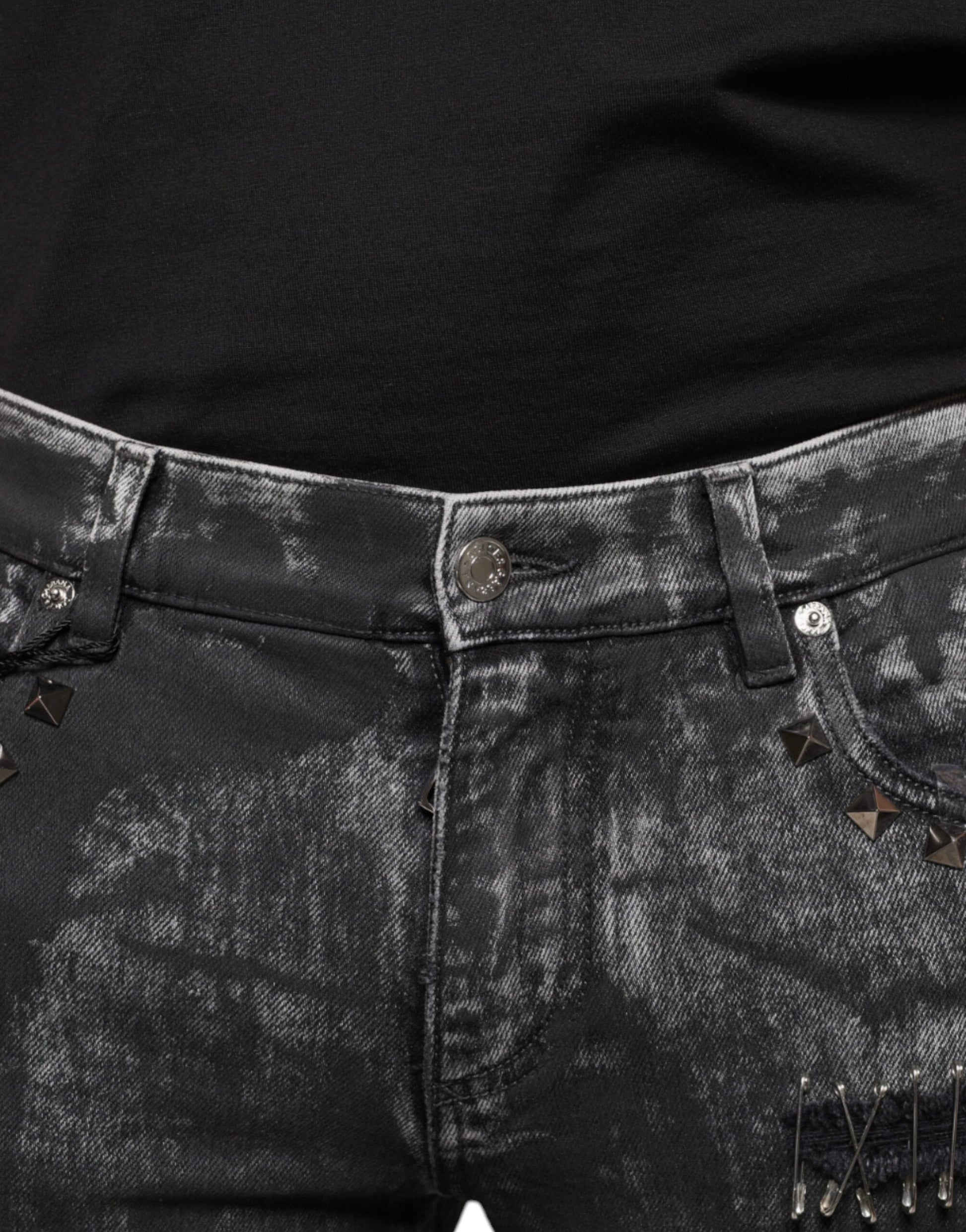 Black distressed denim jeans with silver studs on belt loops