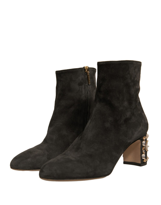 Pair of black suede boots with gold accents