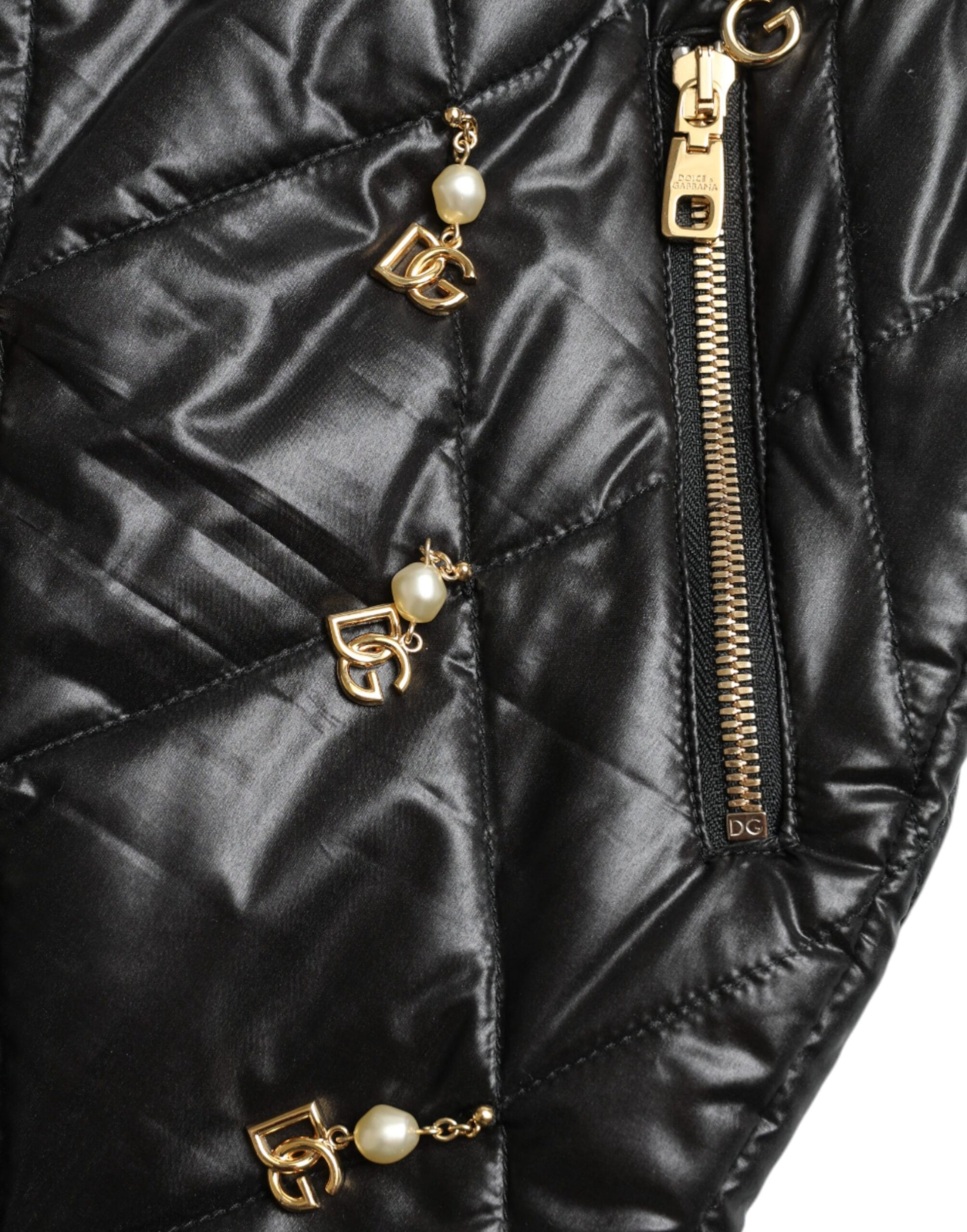 Black quilted jacket with gold zipper pulls featuring pearl accents