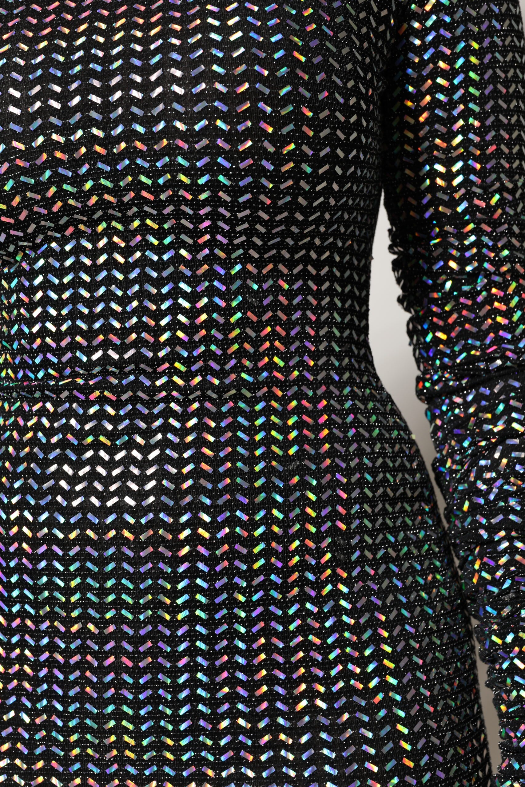 A black bodycon dress with colorful embellishments, designed by Dolce & Gabbana