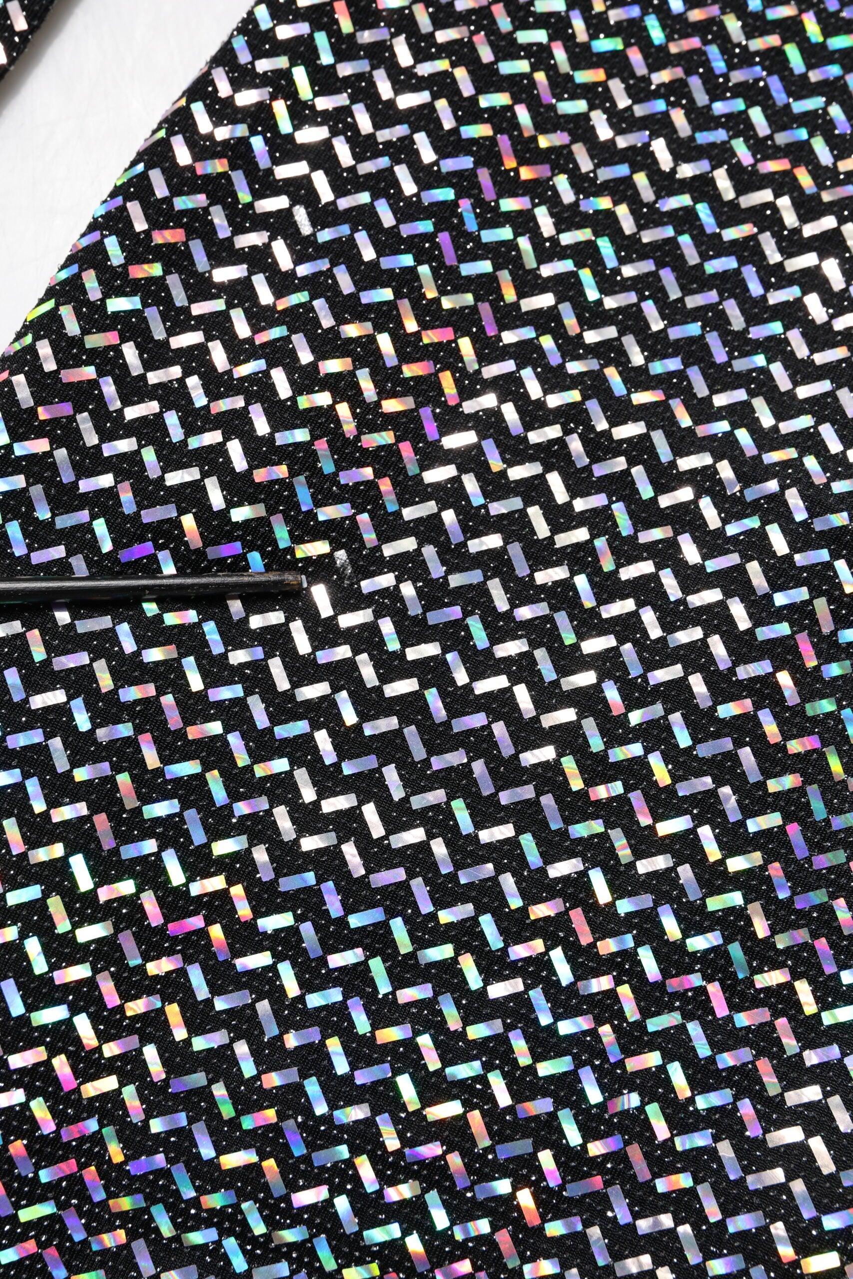 A black nylon dress with colorful embellishments