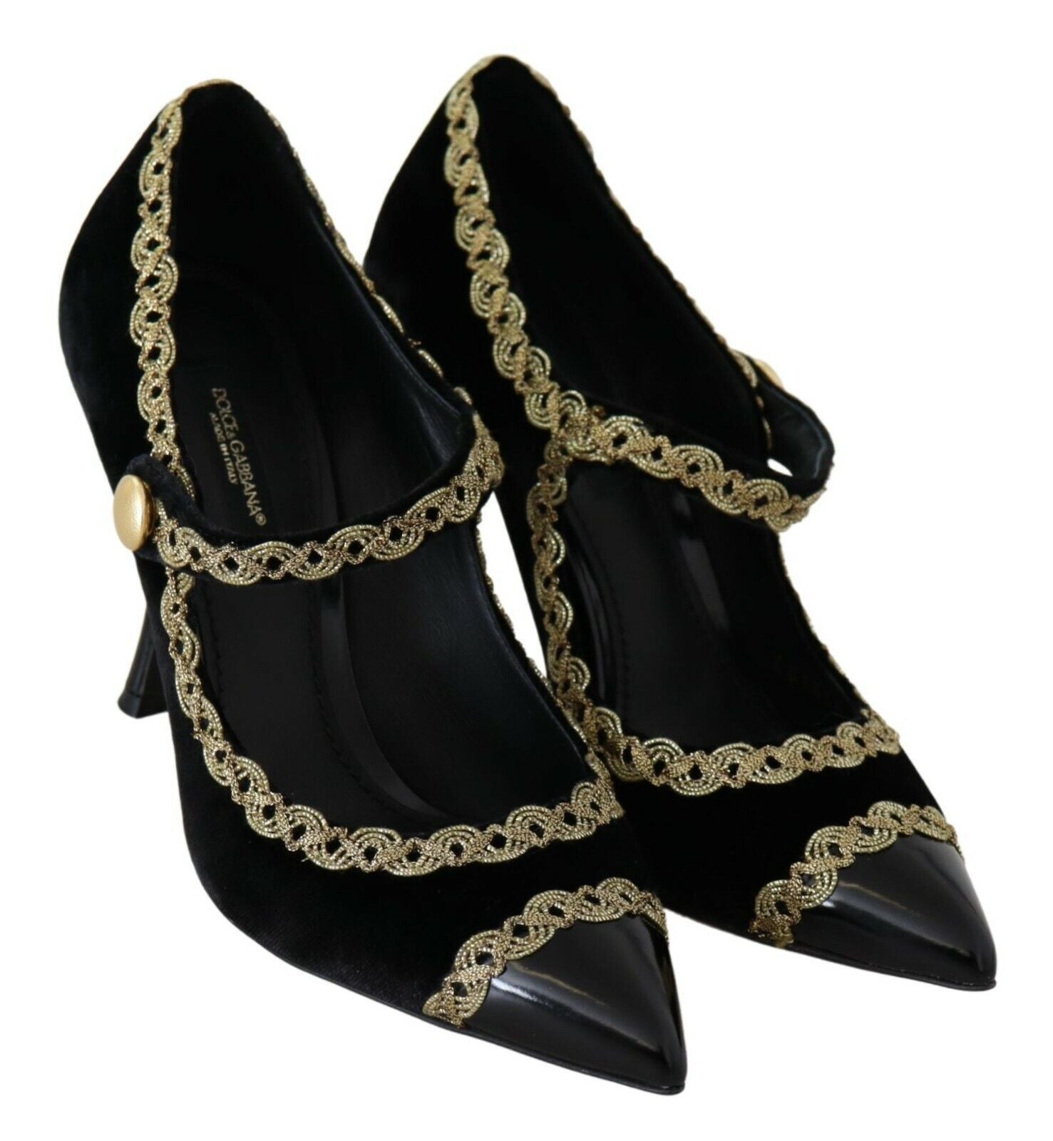 Pair of black high heel shoes with gold accents and a bow on the toe
