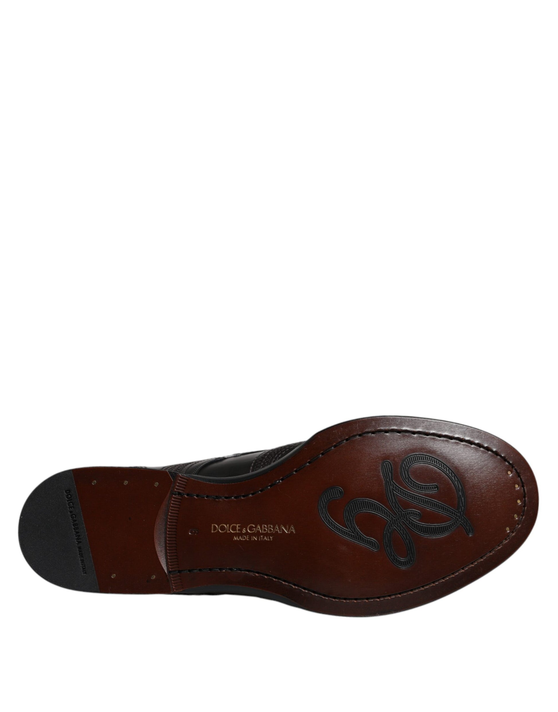 A single black embroidered leather dress shoe with a classic design, featuring the brand name "Dolce & Gabbana" on the side