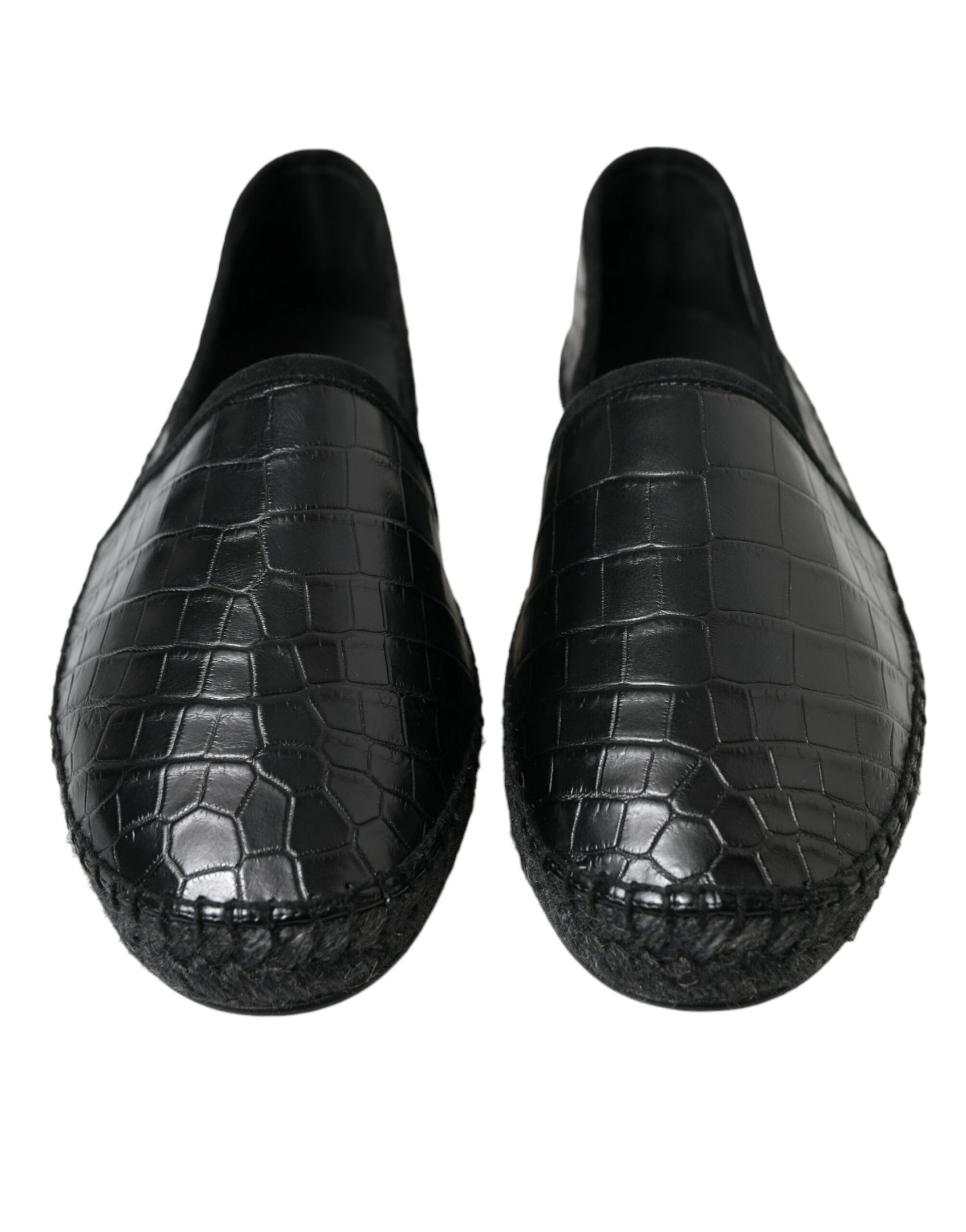 Pair of black loafers with crocodile skin texture and embroidered detailing on soles