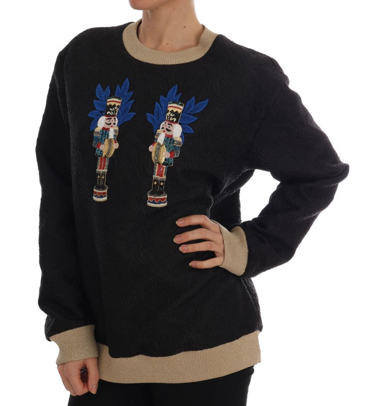 Black sweater with blue and red embroidery on front