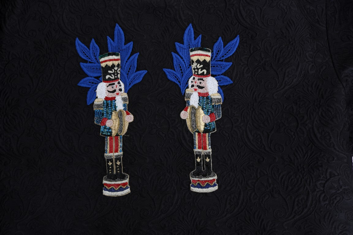 Pair of blue embroidered soldier figurines on black background