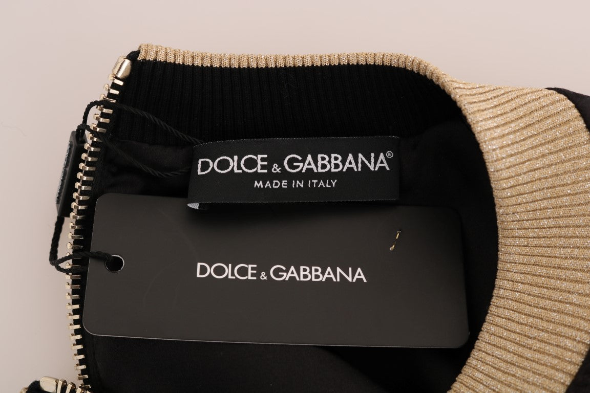 Black sweater with gold trim and tags from Dolce & Gabbana