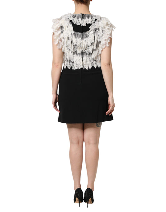 A black dress with embellished shoulders and a short skirt