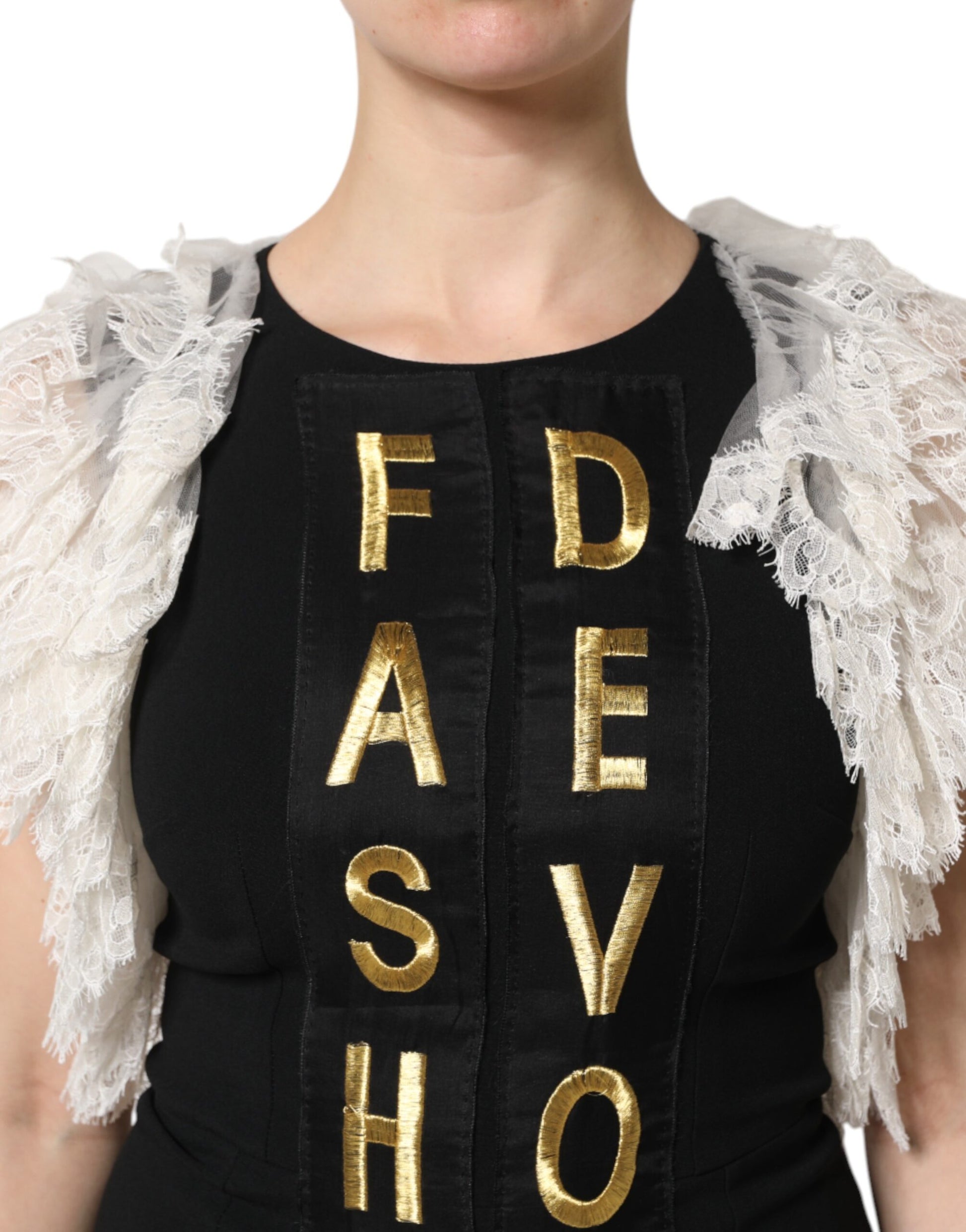 A black dress with gold lettering embellishment spelling out "FASHION DEVOTION"