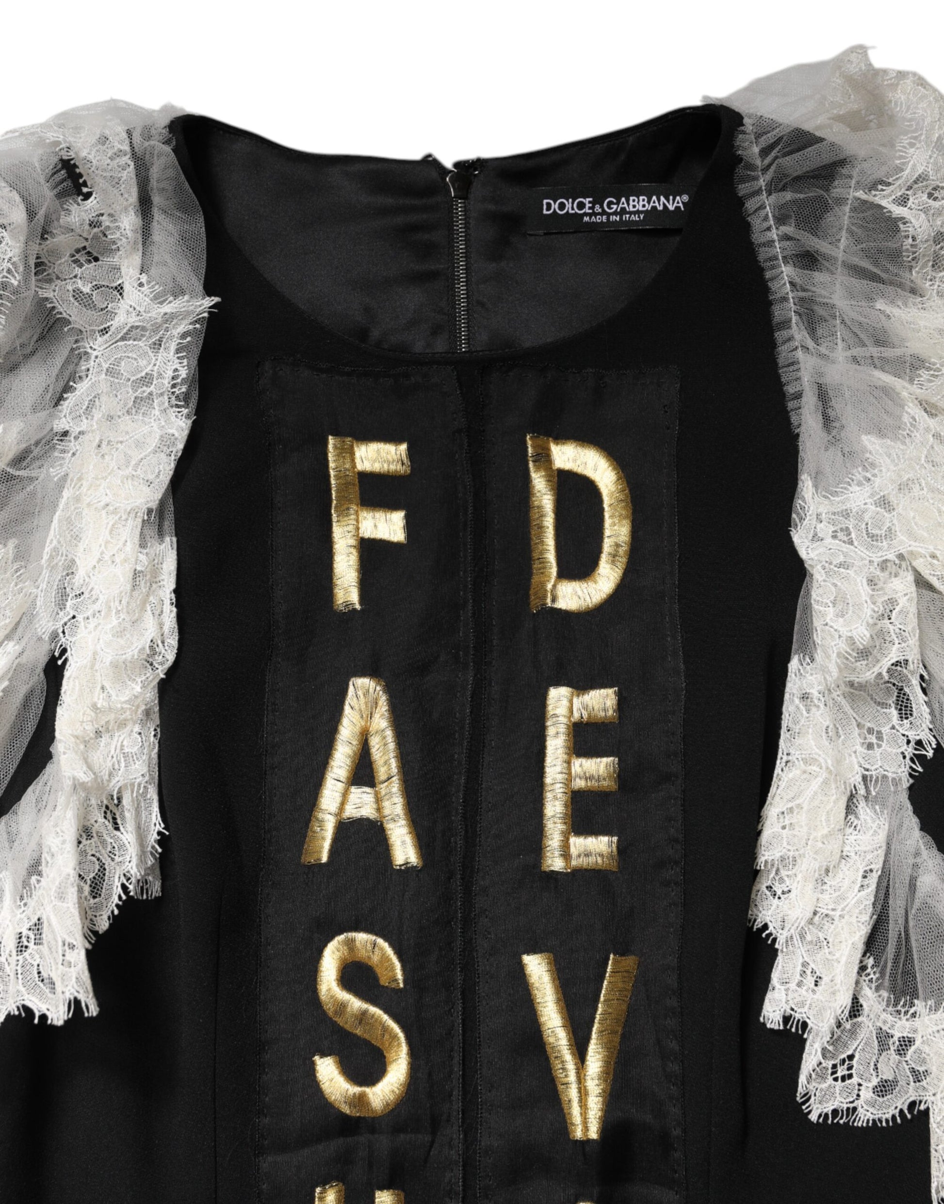 A black dress with gold embellishments, featuring a front panel with the word "DEVOTION" in capital letters