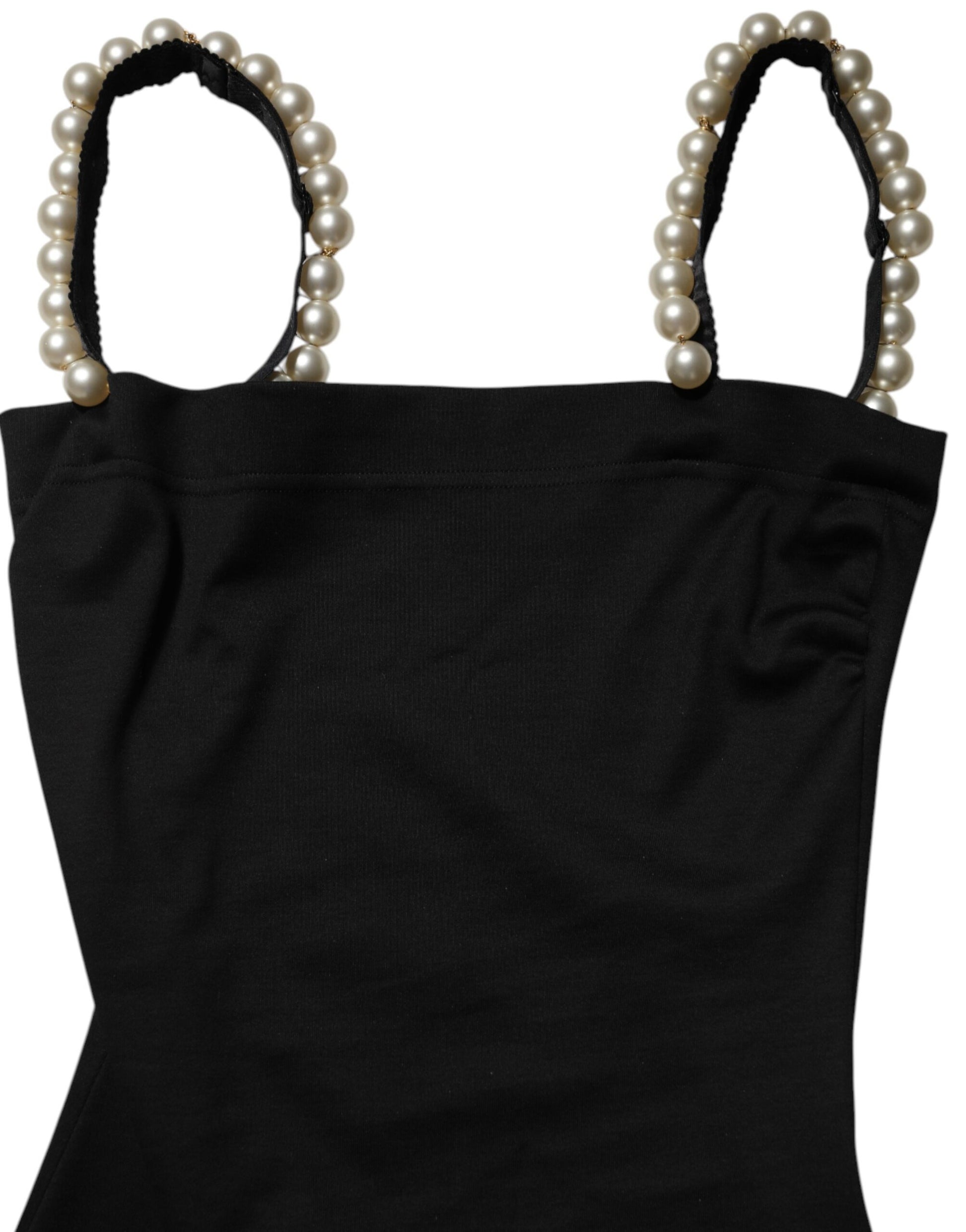 A black dress with faux pearls and a sheath style, featuring a textured fabric