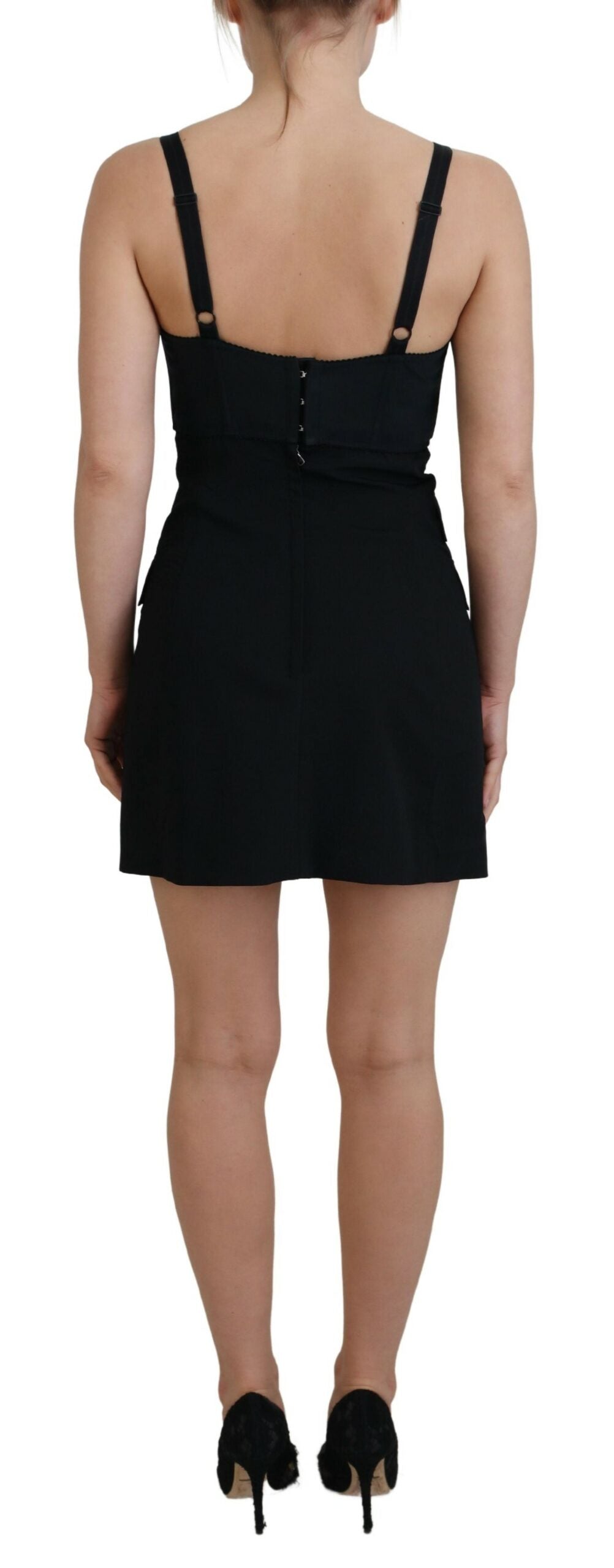 A black dress with a fitted waist, short sleeves and a V-neckline