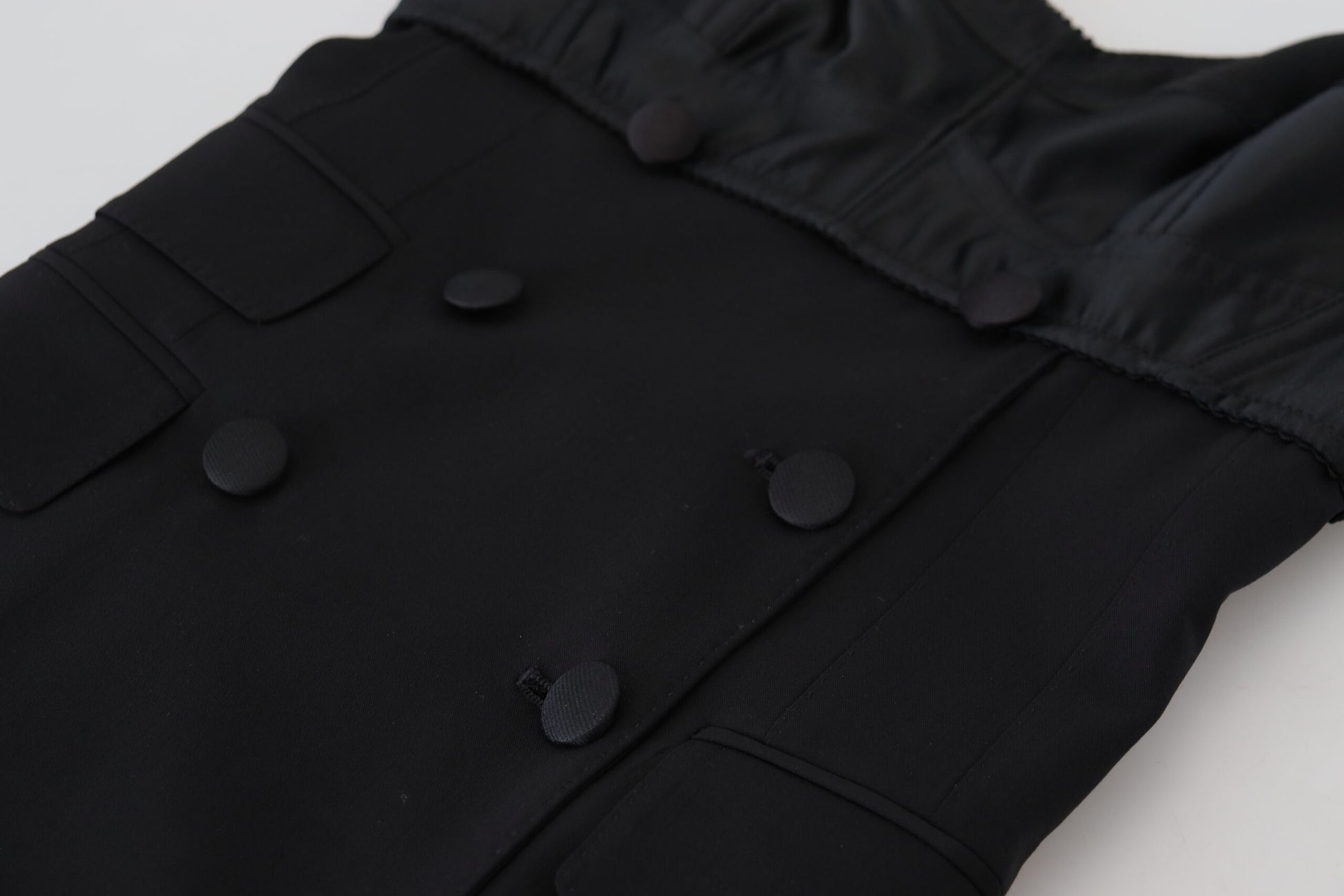 A black dress with buttons on the front