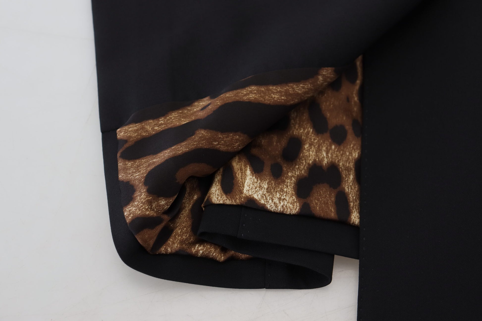 A black dress with a leopard print pattern on the sleeve and waistband