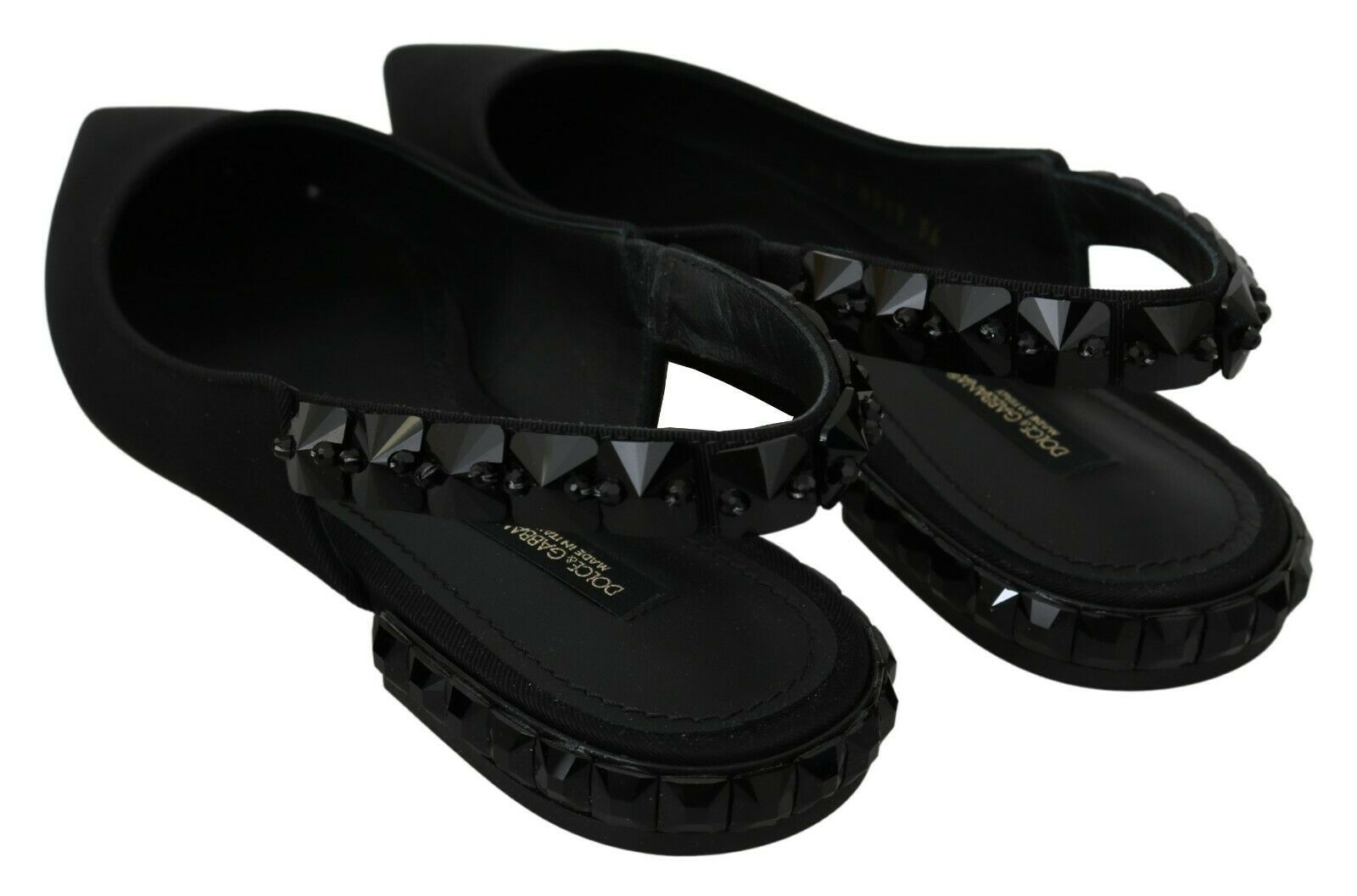 Pair of black sandals with studded detailing on soles