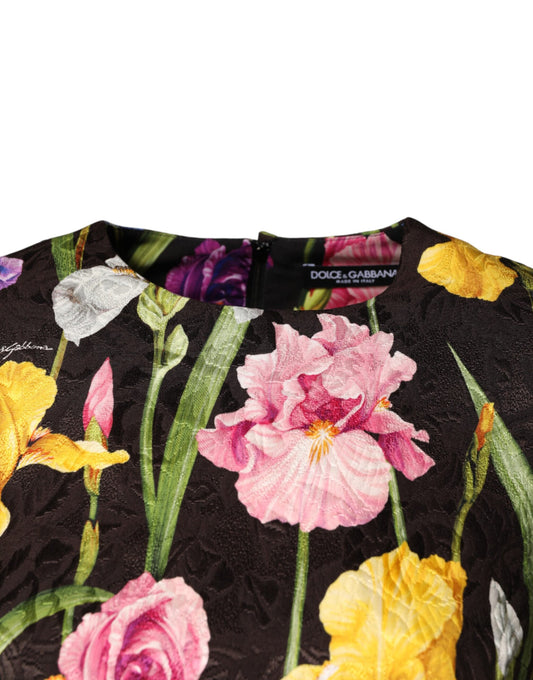A black floral brocade mini dress with a vibrant flower pattern