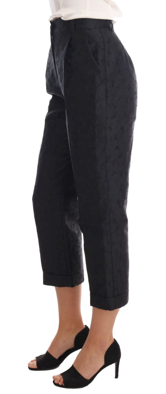 Pair of black trousers with a high waist and rolled up legs