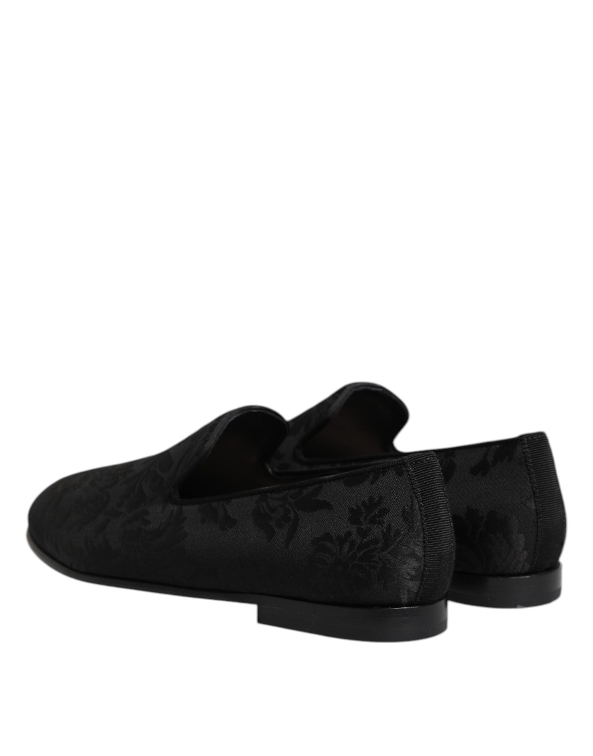 A pair of black loafers with a floral brocade pattern, designed by Dolce & Gabbana