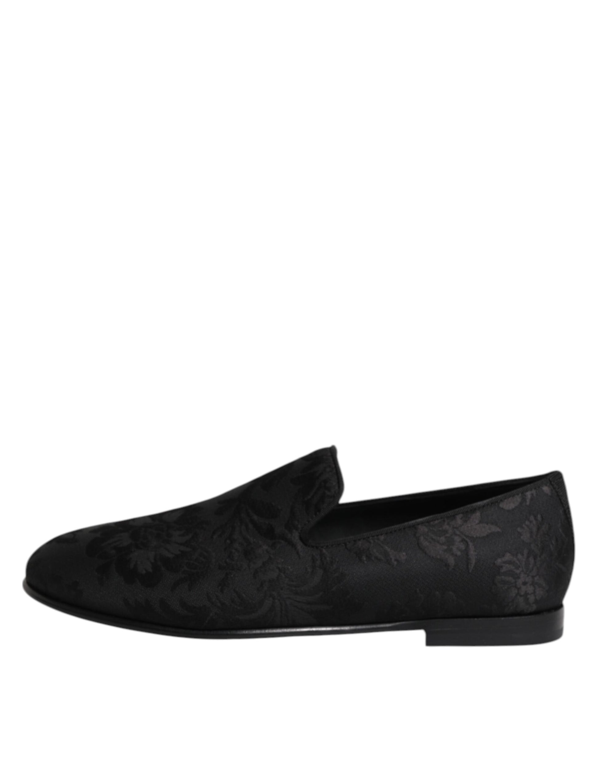 A pair of black floral brocade loafers with a bow on the side, designed for men