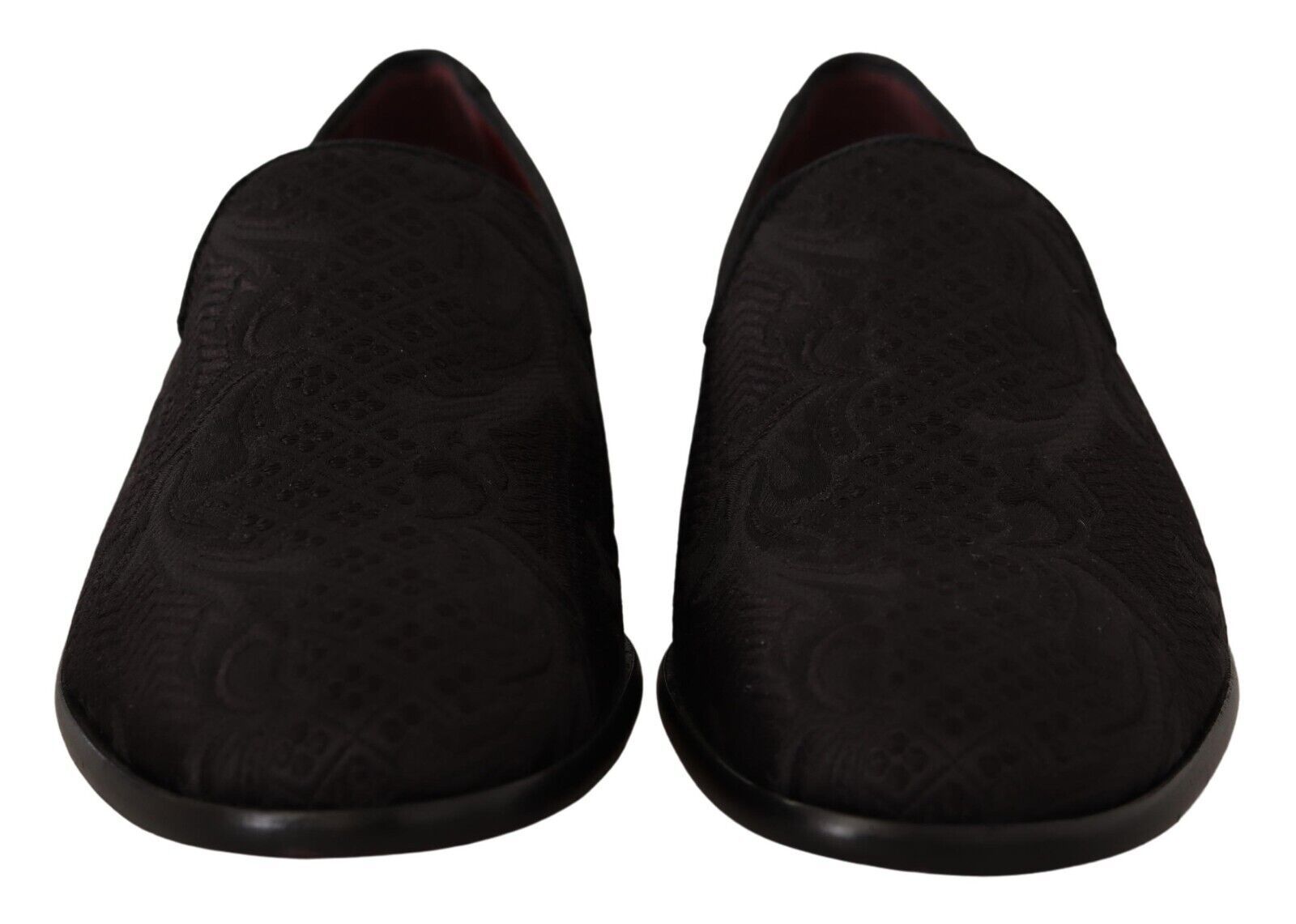 Pair of black slippers with embroidered design on soles