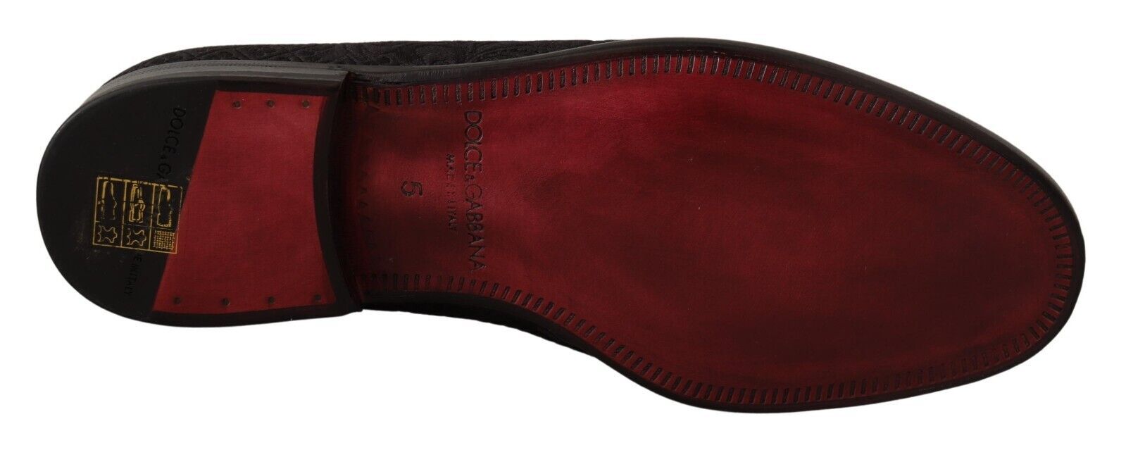 Red shoe with laces and a yellow tag on the tongue
