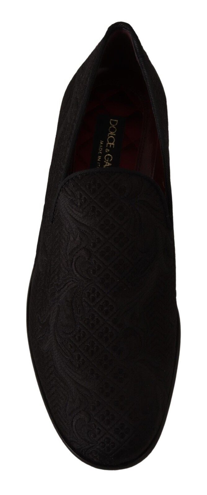 Pair of black velvet loafers with patterned design on side and heel