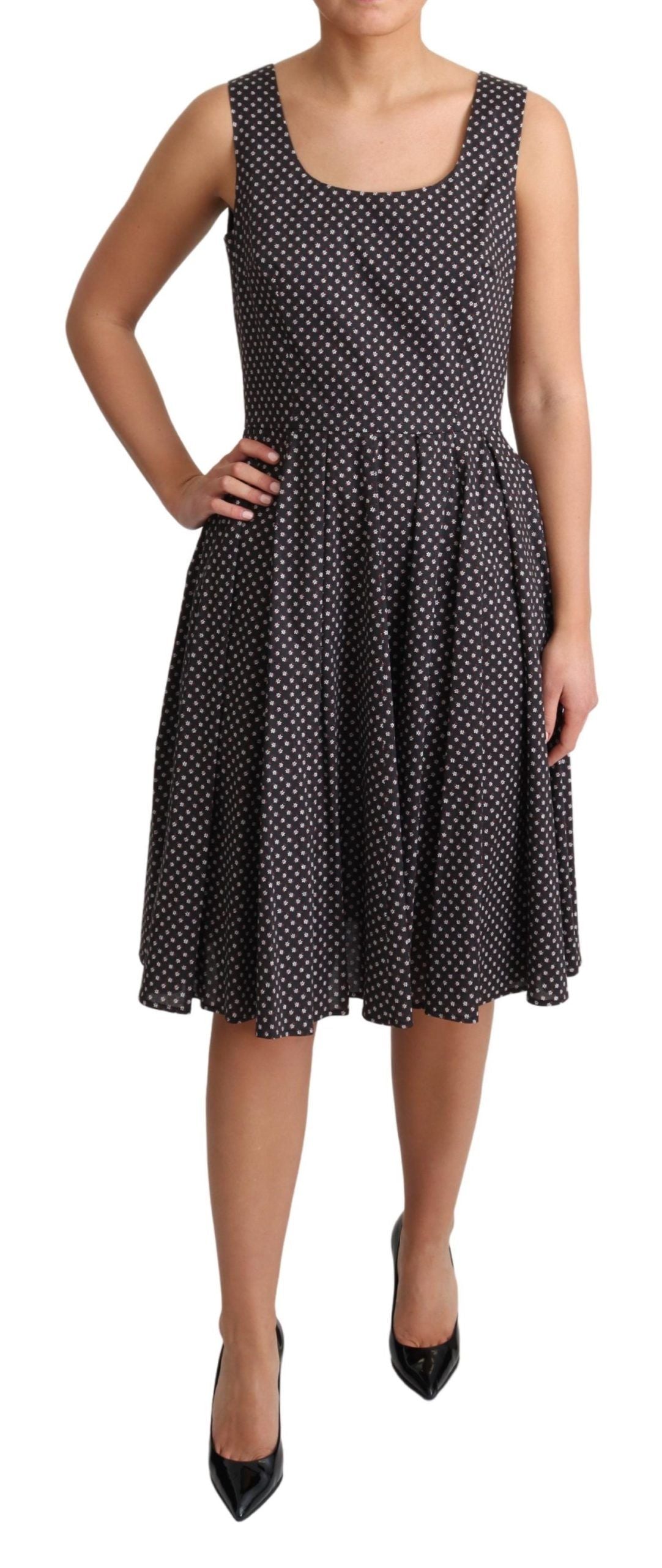 A black dress with white polka dots, featuring a stretchy cotton fabric and an A-line skirt