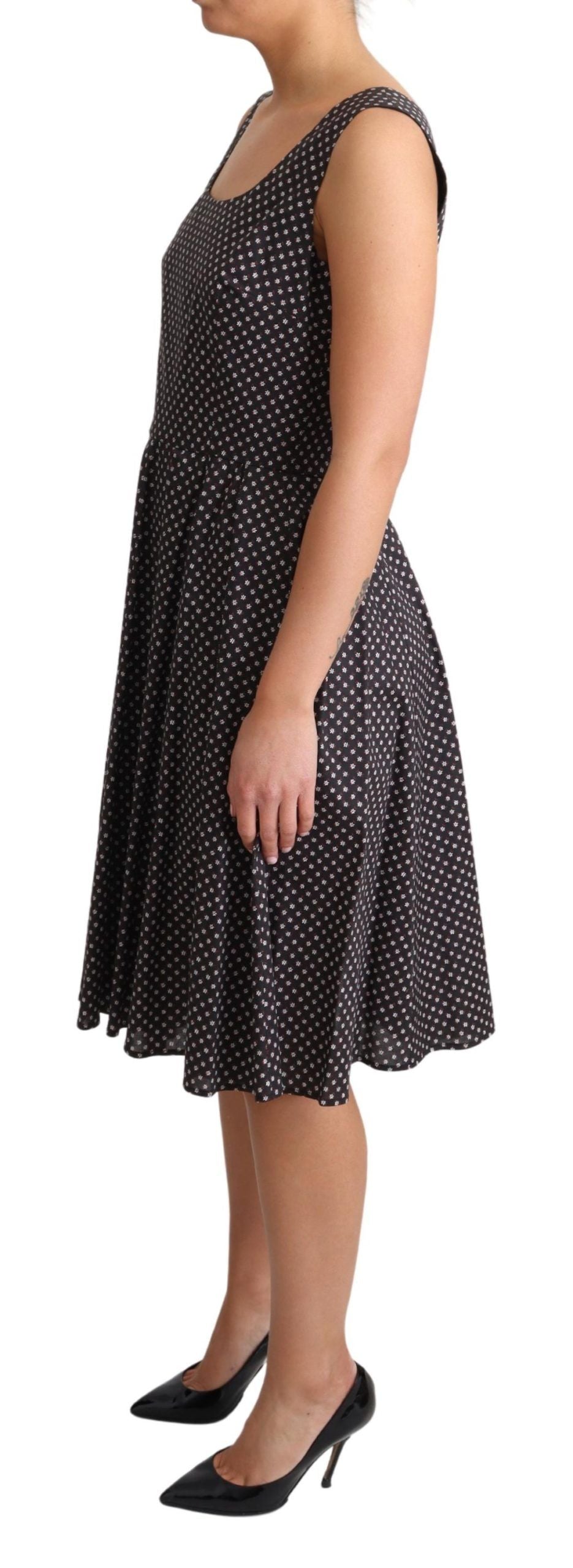 A black dress with white polka dots, featuring a stretchy cotton fabric and an A-line silhouette