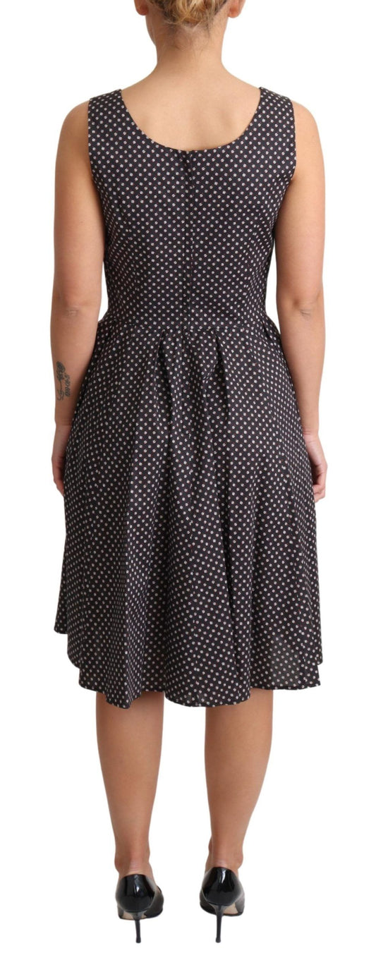 A black dress with white polka dots, featuring a stretchy cotton fabric and an A-line silhouette