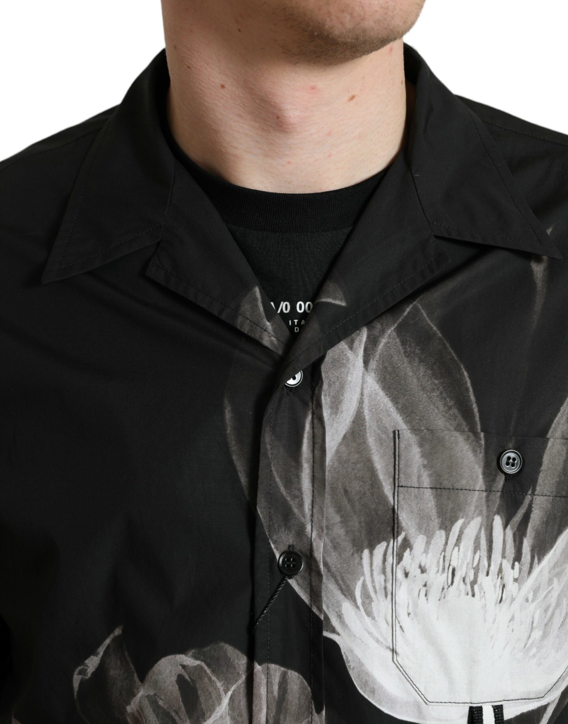 Man wearing black shirt with white design on front