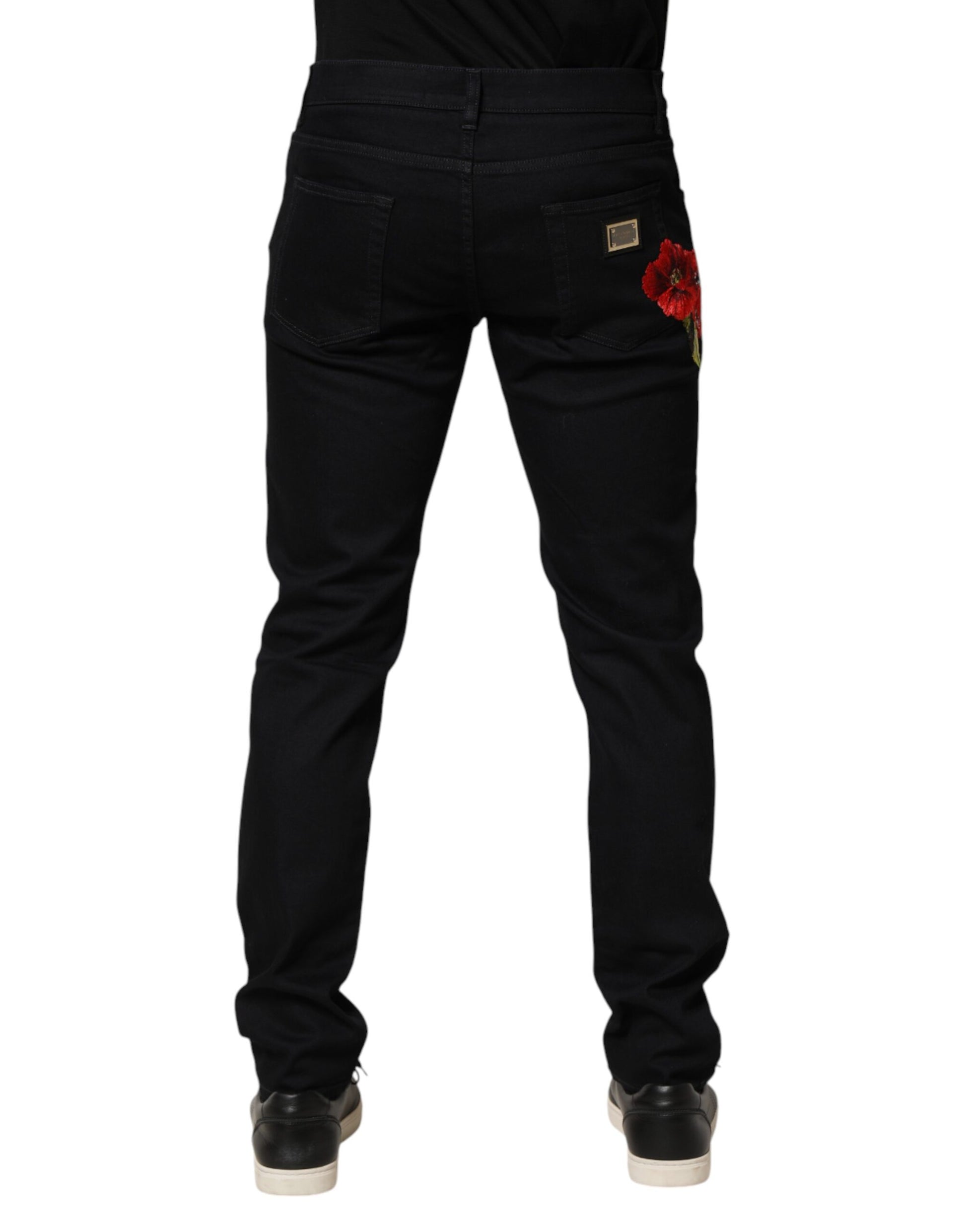 Black denim jeans with red flower embroidery on right leg