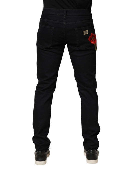 Black denim jeans with red flower embroidery on right leg