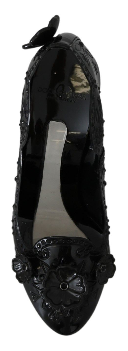 Black high heel shoe with embellishments and a bow on top