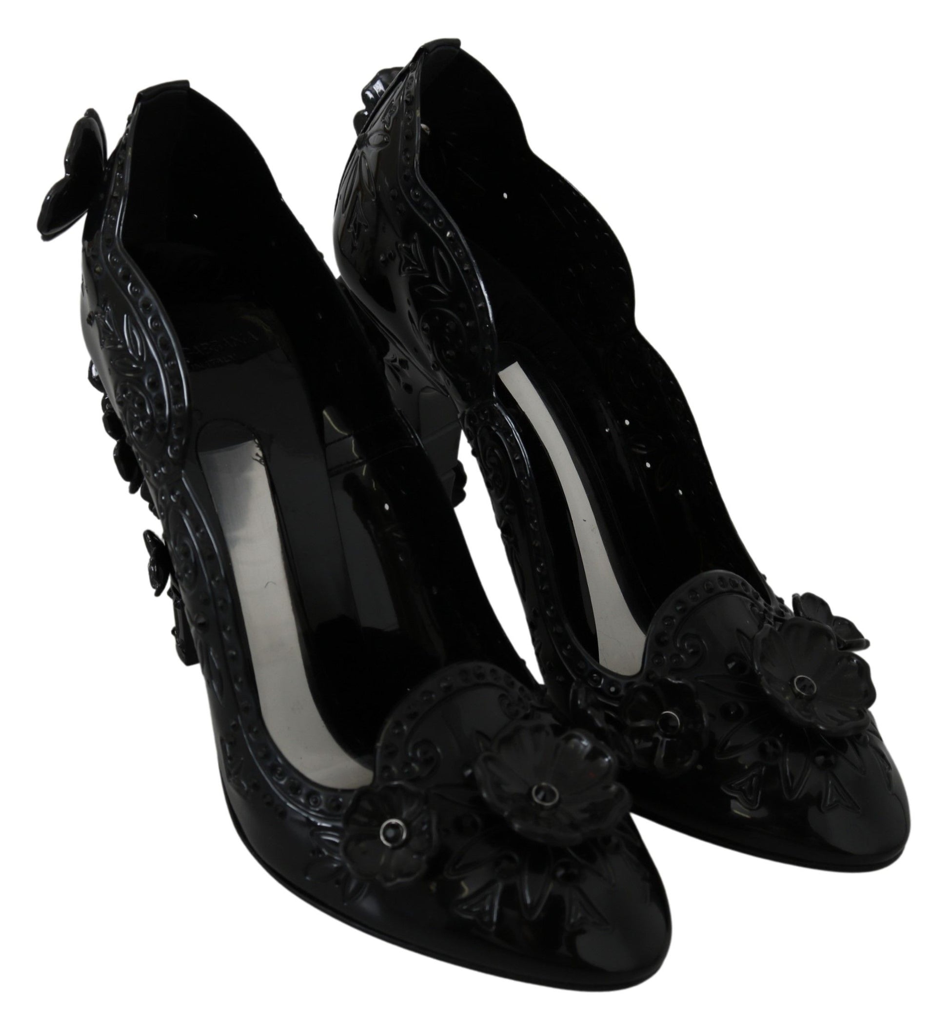 Pair of black high heel shoes with floral embellishments and a white stripe down center