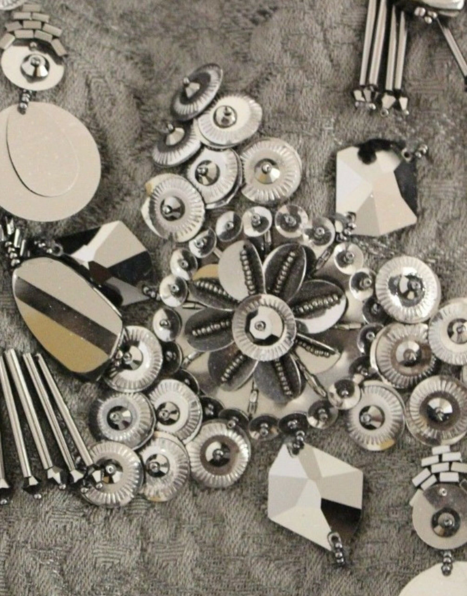 Silver metal buttons on a fabric background