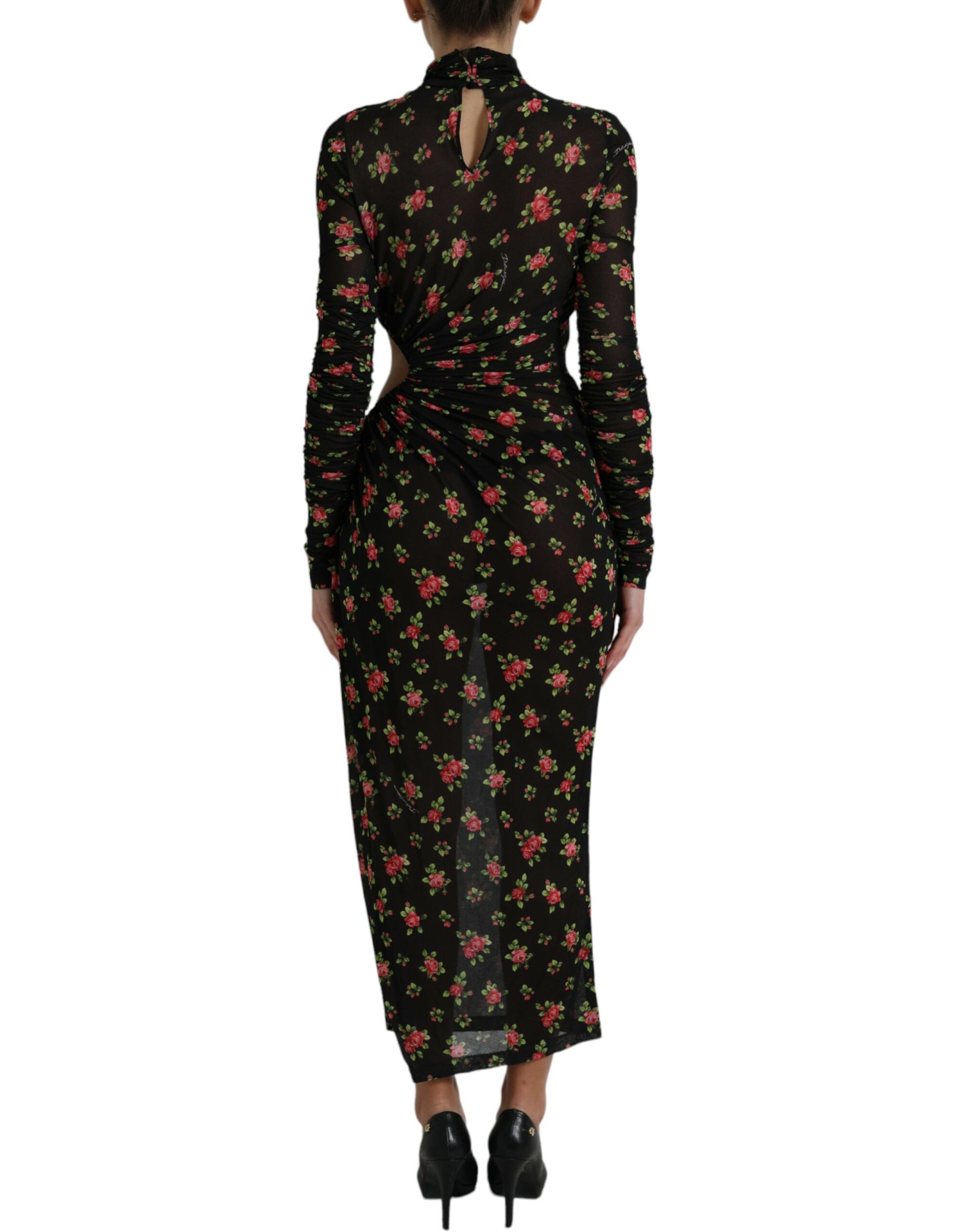 A long black dress with floral cut outs and a high neckline