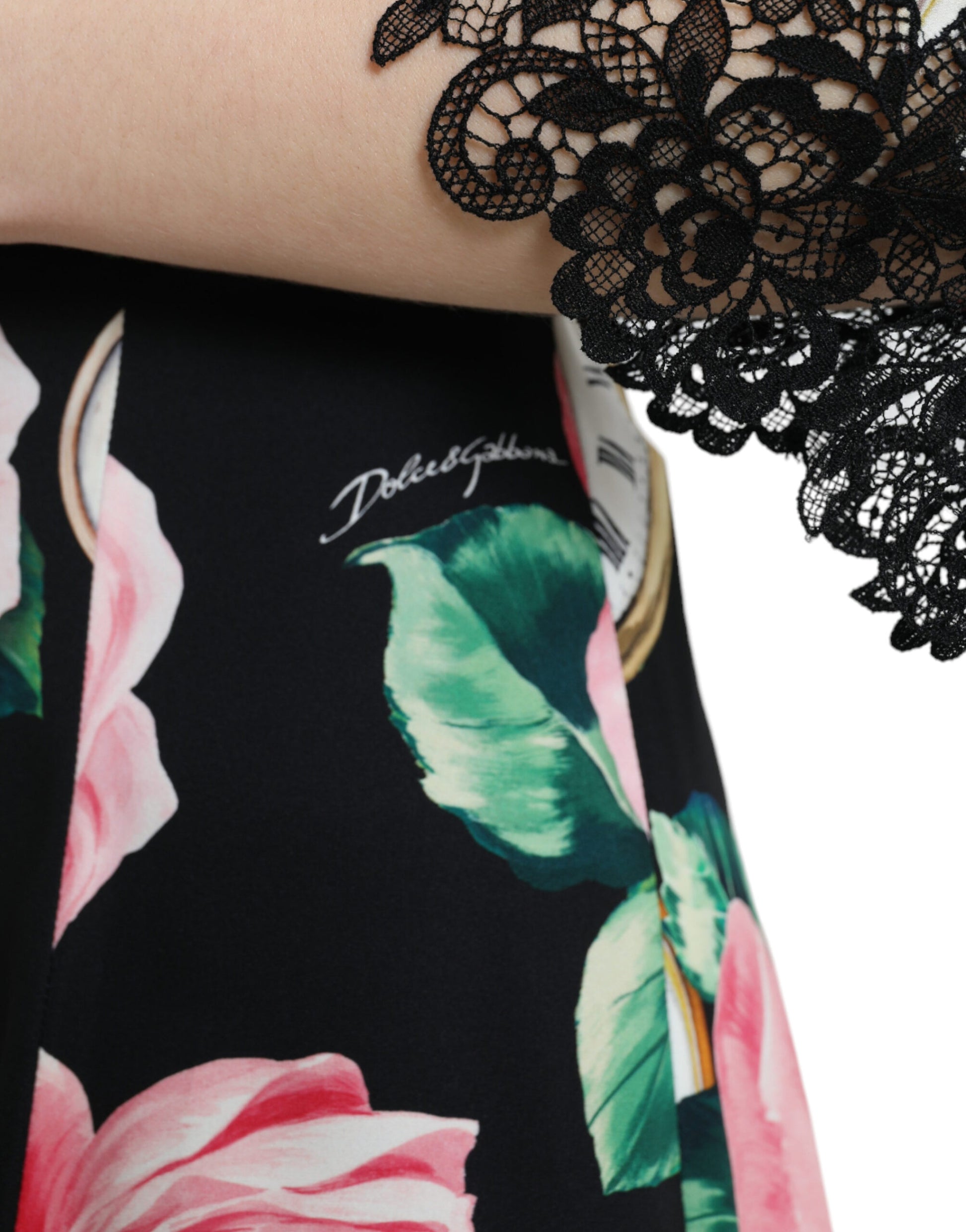 A black floral dress with lace embellishments and a pink flower pattern