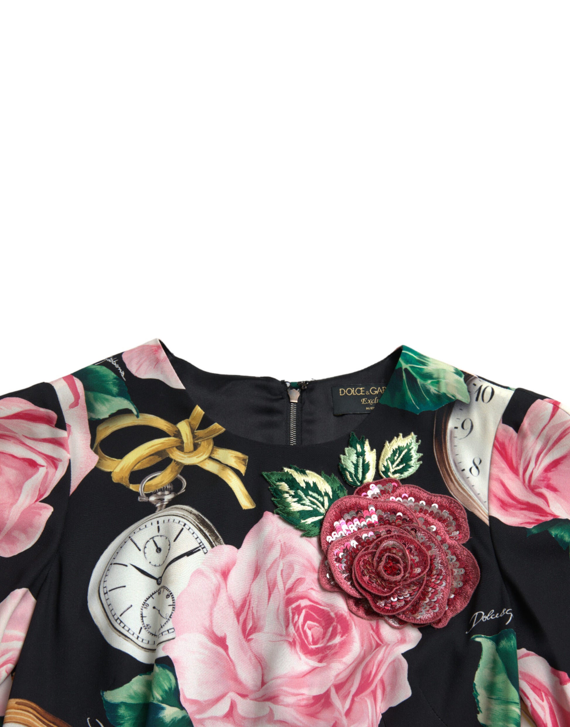 A black dress with floral embellishments and lace details. It features a pink rose design on the bodice, a cl