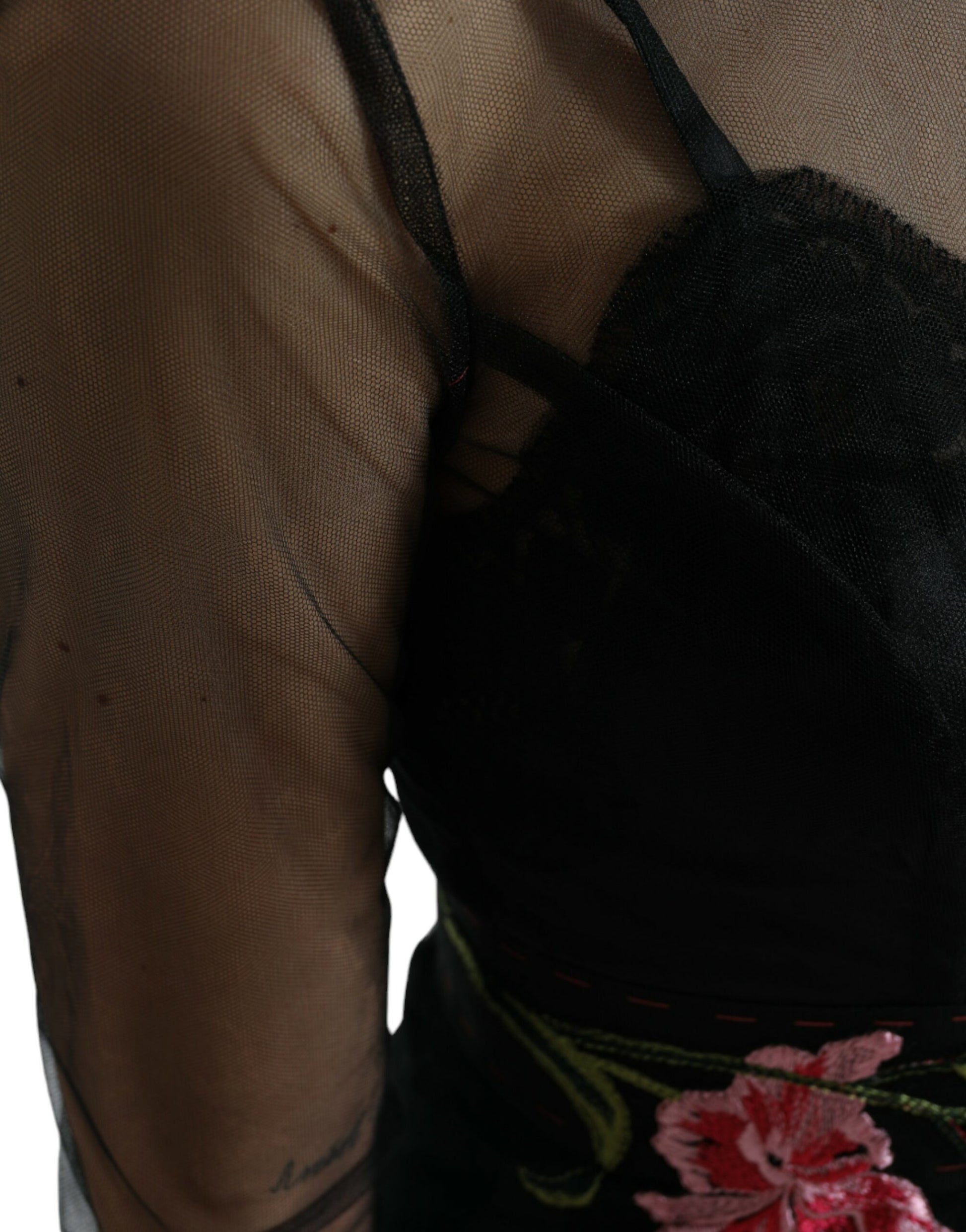A black mesh dress with floral embroidery and tulle overlay